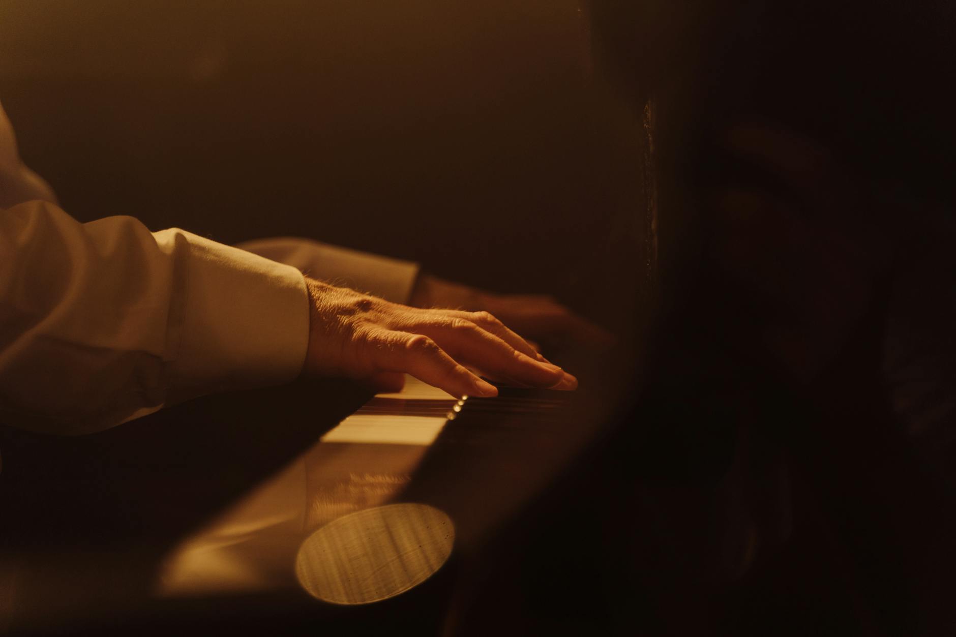 Piano keys in warm golden candlelight