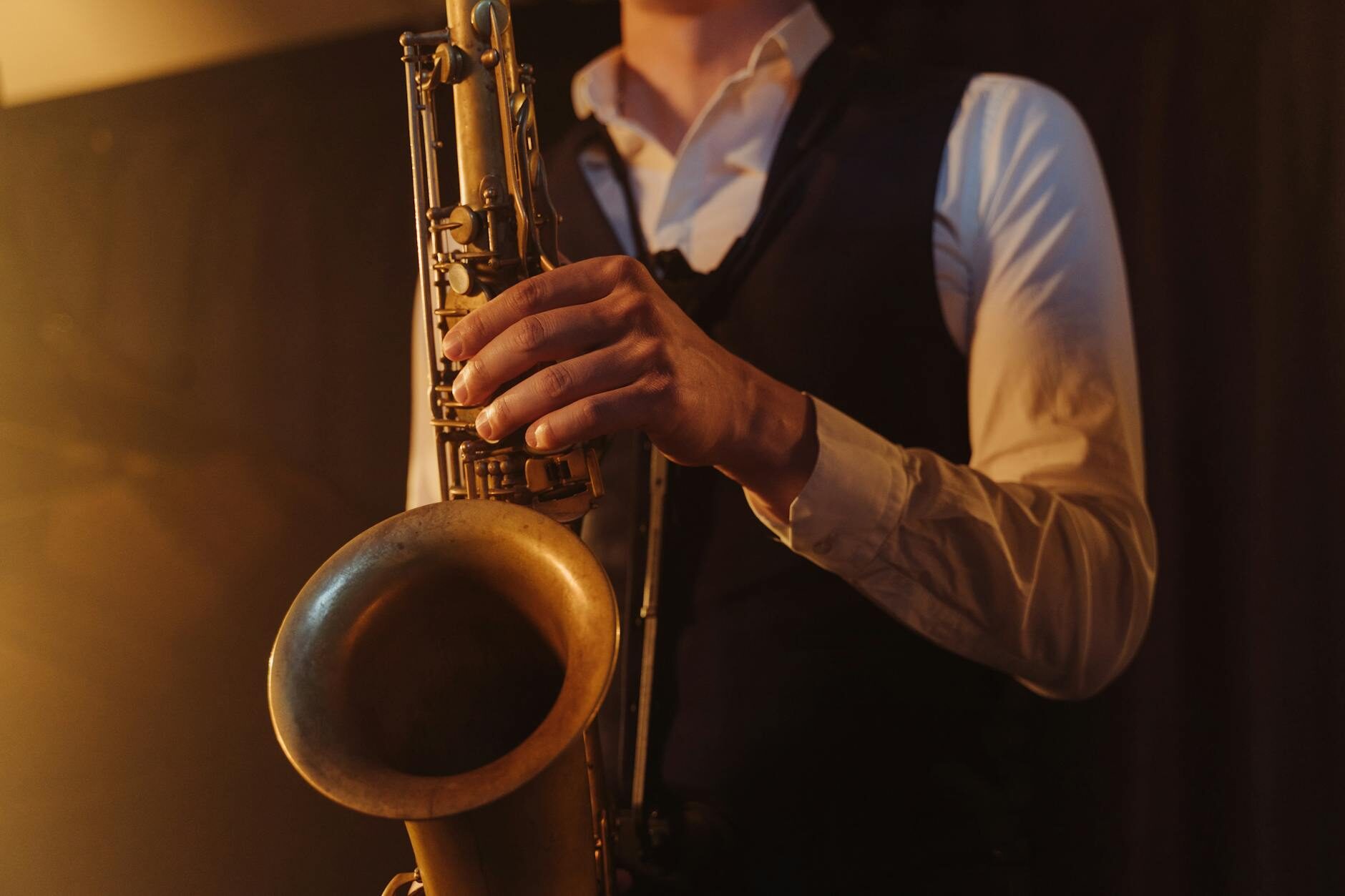 Saxophone keys close-up in warm amber stage lighting